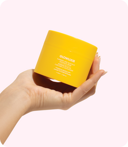 Glowlixir Turmeric & Glycolic Radiance Mask in hand with bright, radiant skin in background